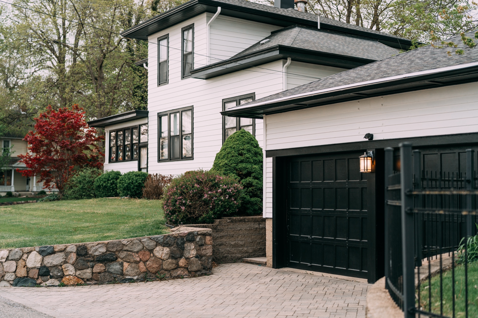 Restored white siding and black garage door