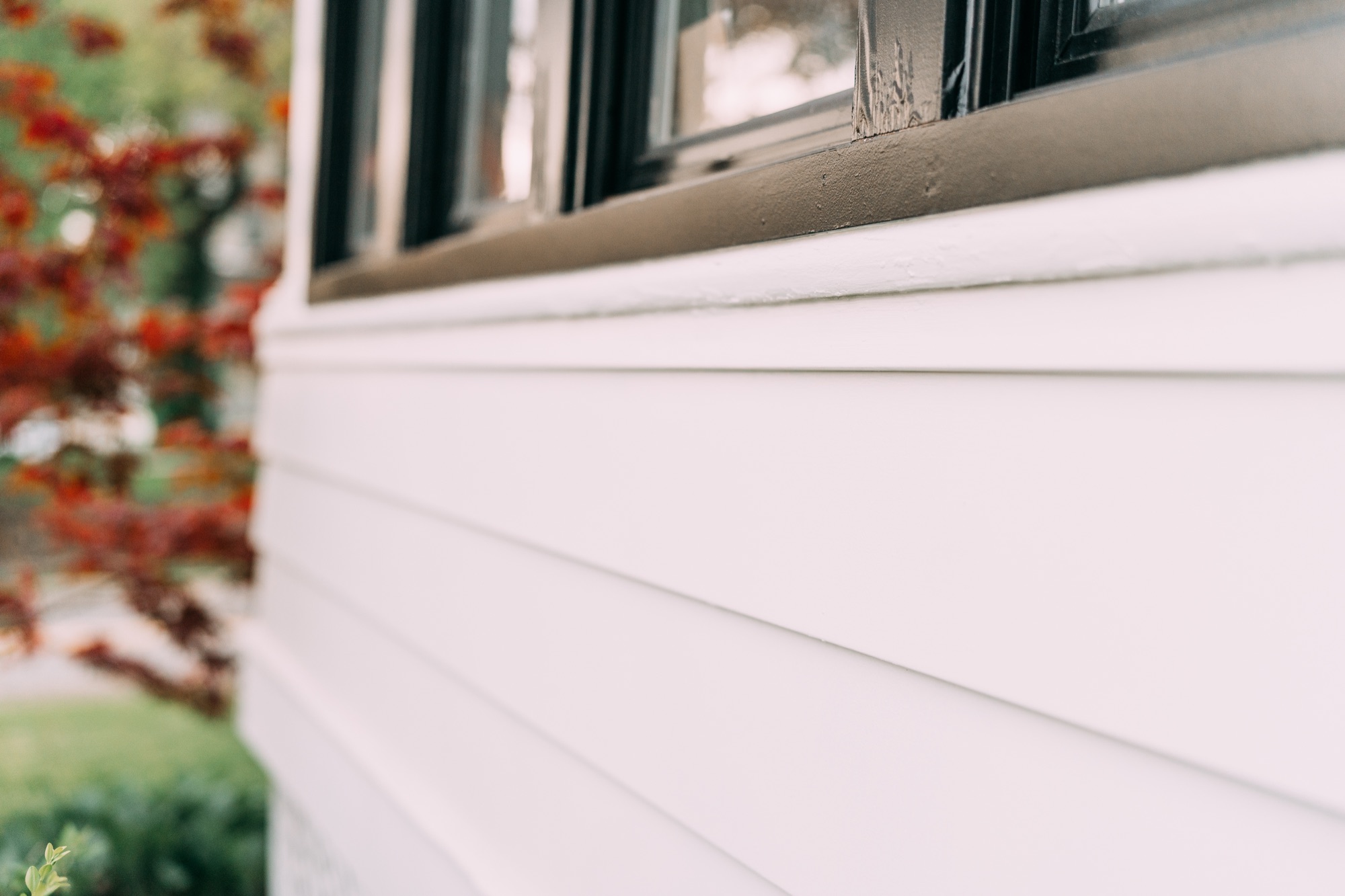 Close-up of sanded and hand-brushed siding and window trim